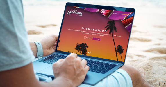 Man on an incentive travel trip working on laptop on the beach